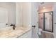 A stylish bathroom featuring a vanity with granite countertop, modern fixtures, and a glass shower with a mosaic tile floor at 1042 Muscovy Pl., Conway, SC 29526