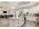 Beautiful kitchen with granite countertops, a center island with a sink, and a view of the Gathering room with a fireplace at 1042 Muscovy Pl., Conway, SC 29526