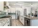 This kitchen includes white cabinets with black hardware, granite countertops, a breakfast bar, and stainless steel appliances at 1042 Muscovy Pl., Conway, SC 29526