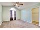 Bright bedroom with a ceiling fan, large window, carpet, and an en suite bathroom at 105 Wagon Wheel Ln., Surfside Beach, SC 29575