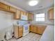 Efficient kitchen with oak cabinets, white appliances, and neutral tile flooring at 105 Wagon Wheel Ln., Surfside Beach, SC 29575