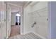 Bright laundry area with wire shelving, and view of a bedroom with carpet and a ceiling fan at 105 Wagon Wheel Ln., Surfside Beach, SC 29575