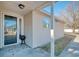 Inviting side porch featuring a glass door, offering a cozy entry and outdoor living space at 105 Wagon Wheel Ln., Surfside Beach, SC 29575