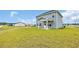 View of the home's exterior with a well-maintained lawn and back porch at 1064 Jase Dr., Longs, SC 29568