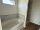 Bathroom featuring bathtub, shower, and marble tile surround at 1064 Jase Dr., Longs, SC 29568