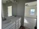 Bathroom featuring a double sink vanity and an open doorway to a bedroom at 1064 Jase Dr., Longs, SC 29568