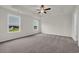 A spacious bedroom features neutral tones, large windows, and a ceiling fan for optimal comfort at 1064 Jase Dr., Longs, SC 29568