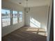 A sunny dining area with pond views through three large windows at 1064 Jase Dr., Longs, SC 29568