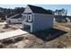 A gray home with a two-car garage featuring a newly poured driveway at 1064 Jase Dr., Longs, SC 29568