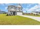 Beautiful two-story home with a well-kept lawn and a long driveway at 1064 Jase Dr., Longs, SC 29568