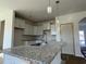 A modern kitchen with white cabinets, gray countertops and stainless steel fixtures at 1064 Jase Dr., Longs, SC 29568