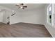 Spacious living room with wood-look floors, neutral walls, and staircase view at 1064 Jase Dr., Longs, SC 29568