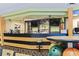 Bar area with stools, bowling balls in the foreground, and televisions overhead for customers to watch games on tv at 1105 S Ocean Blvd. # 604, Myrtle Beach, SC 29577