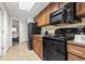 This kitchen features updated appliances and wooden cabinets to complement the granite countertops at 1105 S Ocean Blvd. # 604, Myrtle Beach, SC 29577