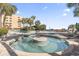 Outdoor pool and hot tub area surrounded by palm trees and lounge chairs create a serene and relaxing vacation atmosphere at 1105 S Ocean Blvd. # 604, Myrtle Beach, SC 29577