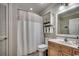 Clean bathroom featuring a shower with a curtain, a white toilet and vanity with a sink and a mirror at 123 Avian Dr. # 102, Pawleys Island, SC 29585