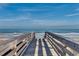 Wooden beach boardwalk featuring ocean views and a sandy beach at 123 Avian Dr. # 102, Pawleys Island, SC 29585