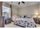 Cozy bedroom featuring a queen-sized bed with seashell patterned bedding and a white crib near a window at 123 Avian Dr. # 102, Pawleys Island, SC 29585