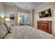 Inviting bedroom featuring a queen bed, dresser with TV, and bright window with natural light at 123 Avian Dr. # 102, Pawleys Island, SC 29585