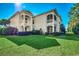 Beautiful two-story home with a well-maintained lawn and inviting balconies, showcasing its charming curb appeal at 123 Avian Dr. # 102, Pawleys Island, SC 29585