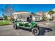 Green golf cart in front of garages, offering convenient transportation around the community at 123 Avian Dr. # 102, Pawleys Island, SC 29585