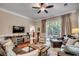 Relaxing living room with a fireplace and large television, along with sliding glass doors leading outside at 123 Avian Dr. # 102, Pawleys Island, SC 29585