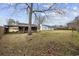 Backyard featuring home, shed, and a large tree at 125 Ole Cedar Ln., Conway, SC 29526