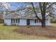 Charming single-story home with light blue siding, mature tree and metal roof at 125 Ole Cedar Ln., Conway, SC 29526