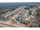 A broad aerial view showing the neighborhood, nearby roads, and community pond at 129 Tomoka Trail, Longs, SC 29568