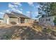 Backyard featuring a patio, storage shed, fire pit and well-manicured lawn perfect for relaxation and entertainment at 129 Tomoka Trail, Longs, SC 29568