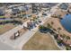 Aerial view of the community entrance with palm trees and attractive landscaping at 129 Tomoka Trail, Longs, SC 29568