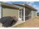 Exterior view of the home showcasing the screened in back porch, grill and outdoor seating at 129 Tomoka Trail, Longs, SC 29568