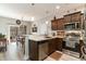 Modern kitchen featuring stainless appliances, dark wood cabinets, and an adjacent dining area at 129 Tomoka Trail, Longs, SC 29568