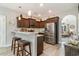 Modern kitchen featuring stainless steel appliances, dark wood cabinets, and a stylish breakfast bar at 129 Tomoka Trail, Longs, SC 29568