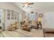 Bright living room with vaulted ceilings, neutral walls, wood-look floors, and a cozy seating arrangement at 129 Tomoka Trail, Longs, SC 29568