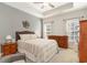 Spacious main bedroom with neutral tones, tray ceiling, and large windows providing natural light at 129 Tomoka Trail, Longs, SC 29568