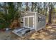 Exterior view of the shed featuring a stone base and a set of double doors at 129 Tomoka Trail, Longs, SC 29568