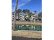 Exterior of building with view of a pond, parking area, and manicured landscaping at 1298 River Oaks Dr. # 5-F, Myrtle Beach, SC 29579