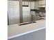 Well-lit kitchen area with white appliances and cabinets, and a sink with laminate floors at 1298 River Oaks Dr. # 5-F, Myrtle Beach, SC 29579