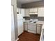Functional kitchen with white appliances, laminate countertops, and a laminate floor at 1298 River Oaks Dr. # 5-F, Myrtle Beach, SC 29579