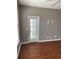 Cozy room featuring high ceilings and laminate floors with a door leading to the outside at 1298 River Oaks Dr. # 5-F, Myrtle Beach, SC 29579