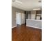 Open-concept living space with laminate floors flowing into the kitchen area, freshly painted at 1298 River Oaks Dr. # 5-F, Myrtle Beach, SC 29579
