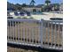 Community pool and sun loungers seen from behind a white fence at 1298 River Oaks Dr. # 5-F, Myrtle Beach, SC 29579