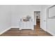 Light and airy bedroom showcasing hard wood floors, a dresser with a television and lamps at 140 Northside Dr., Little River, SC 29566