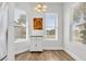 Cozy breakfast nook featuring a charming light fixture, bright windows, and a functional kitchen cart at 140 Northside Dr., Little River, SC 29566