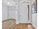 Bright foyer with hardwood floors featuring white doors, trim and a painting at 140 Northside Dr., Little River, SC 29566