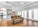 Spacious living room featuring hardwood floors and couch, with views to kitchen and dining areas at 140 Northside Dr., Little River, SC 29566