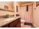 Bathroom featuring granite countertop, bronze faucet, and a pink shower curtain at 1456 Baldwin Ct. # 1456, Little River, SC 29566