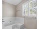 Clean and spacious bathroom featuring a soaking tub, a window with natural light at 172 Hawthorn Dr., Pawleys Island, SC 29585