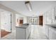 Well-lit kitchen featuring an island with cooktop and view to living room and backyard at 172 Hawthorn Dr., Pawleys Island, SC 29585